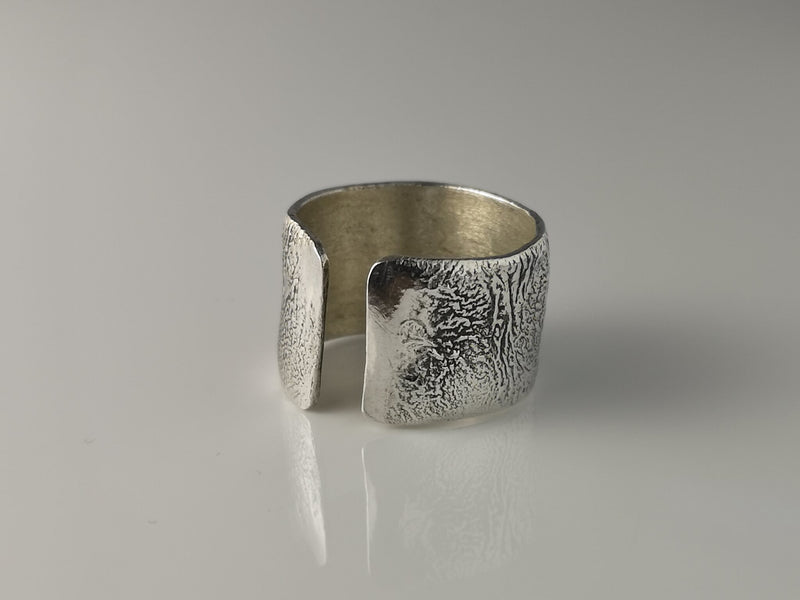 A handmade wide band sterling silver reticulated ring. The process of reticulation creates a truly earthy unique finish which is different every time.